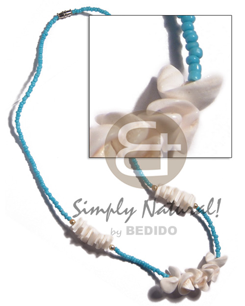 white shells in light blue glass beads - Home